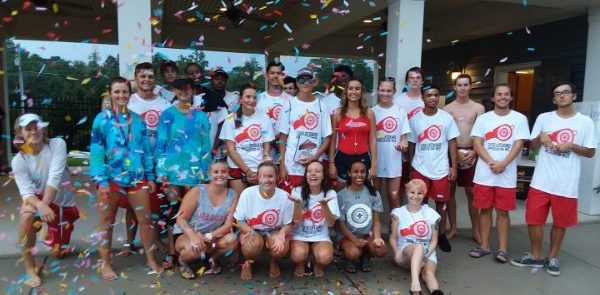 24 lifeguards posing for group photo as confetti falls from above